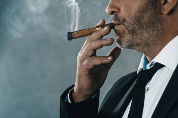 istock businessman with bristle smoking cigar 870785302