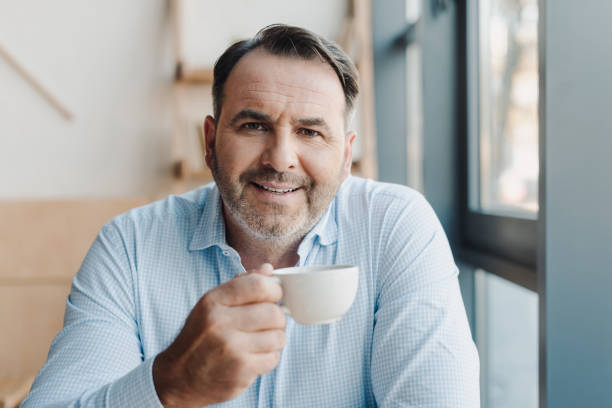 istock businessman with cup of coffee 870788110