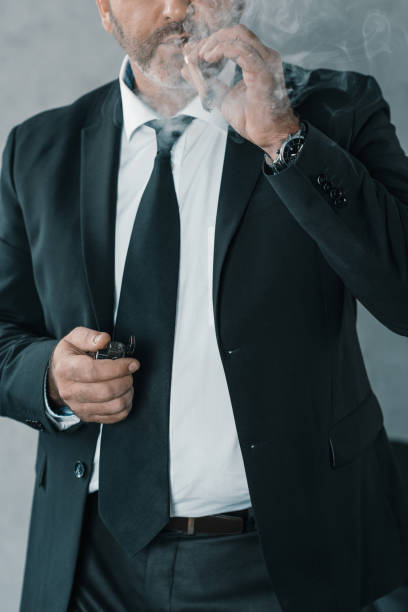 istock businessman smoking cigar 870788446