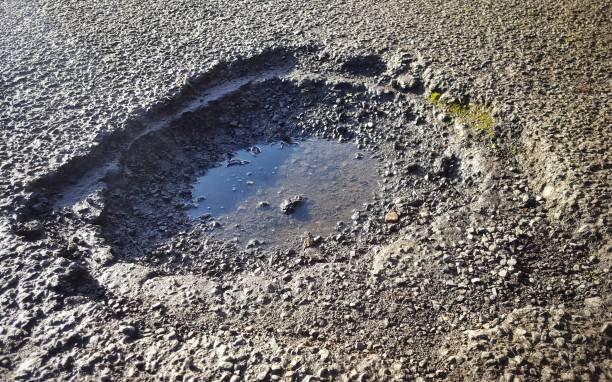 istock Large, deep pothole on a UK tarmac road 870795804
