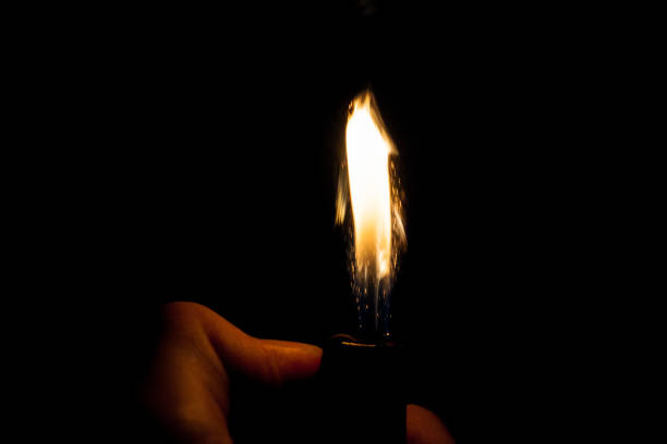 istock Close up view of real sparking light from lighter in dark black background 870796152