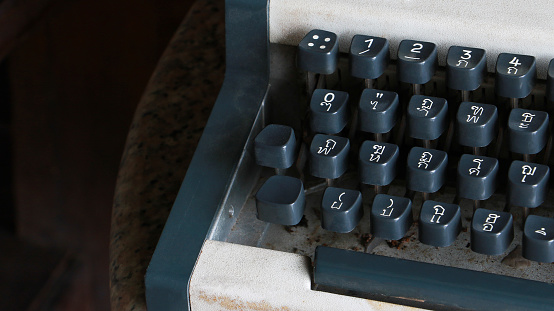 Closeup of Antique typewriter. Vintage typewriter machine with Thai language or Thai alphabet keys. Thai typewriter for background.