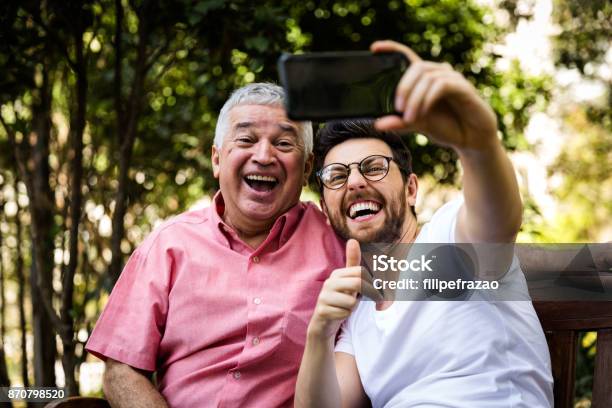 Dad And Son Taking Selfie And Having Fun In The Park Stock Photo - Download Image Now