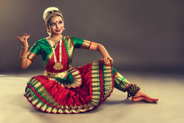 Beauty of classical indian dance. Young woman dancer  is performing indian dance bharatanatyam. Young attractive woman dancer of classical indian dance bharatanatyam, dressed in special dance suit and jewelry set, is demonstraiting simbolic poses of anciant folk dance. bharatanatyam dancing stock pictures, royalty-free photos & images