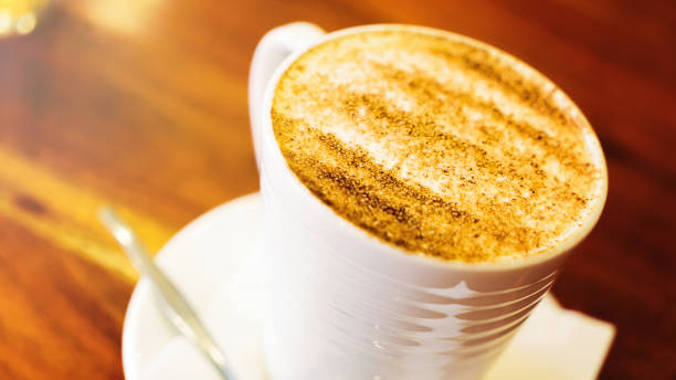 istock cappuccino cup on the brown wooden table 870811156