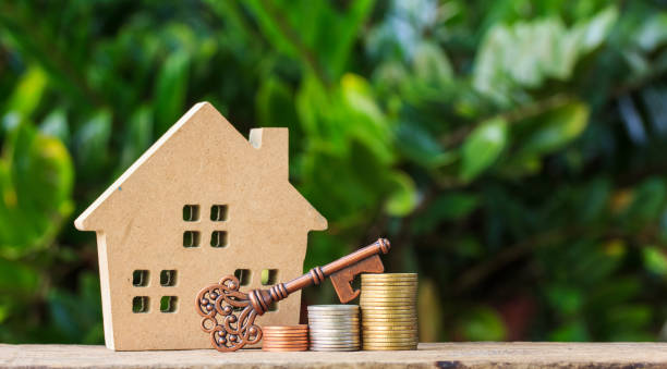 House and Key on stack of coins. stock photo