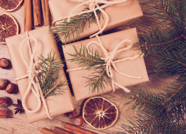 istock Christmas gifts in rustic boxes on wooden background. 870818676