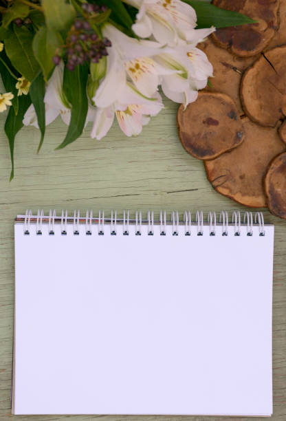 istock Mockup with blank notepad. Blank sheet. A place for the presentation. Wild flowers on green painted wooden background. 870825120