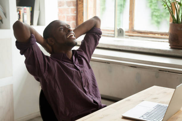 istock Smiling businessman relaxing at workplace in modern office. 870828698