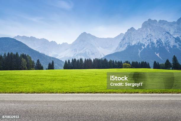 Asphalt Road And Green Meadow Stock Photo - Download Image Now - Road, Mountain, Backgrounds