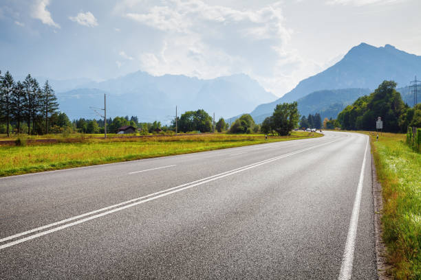 istock Asphalt road and mountains on horizon 870832962