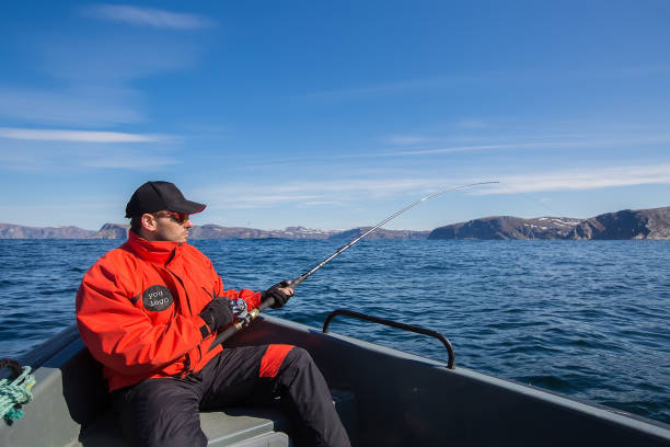 istock Fisherman athlete in a fishing boat. side view 870833828