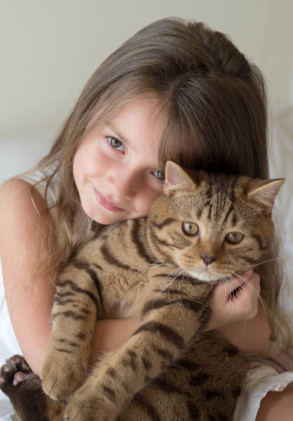Pretty little girl holding her cat