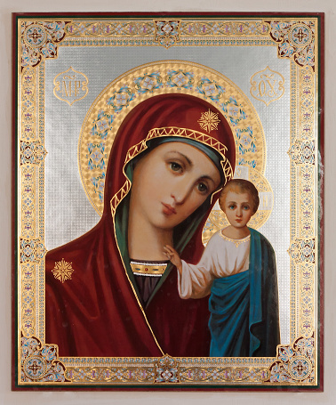 Interior of russian christian orthodox church (detail): icon of the virgin Mary with Jesus baby decorated by golden plate.