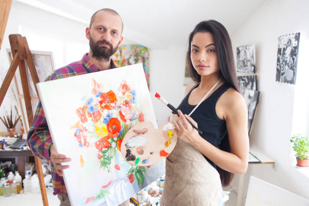 istock Painters presenting flowers painting 870843370
