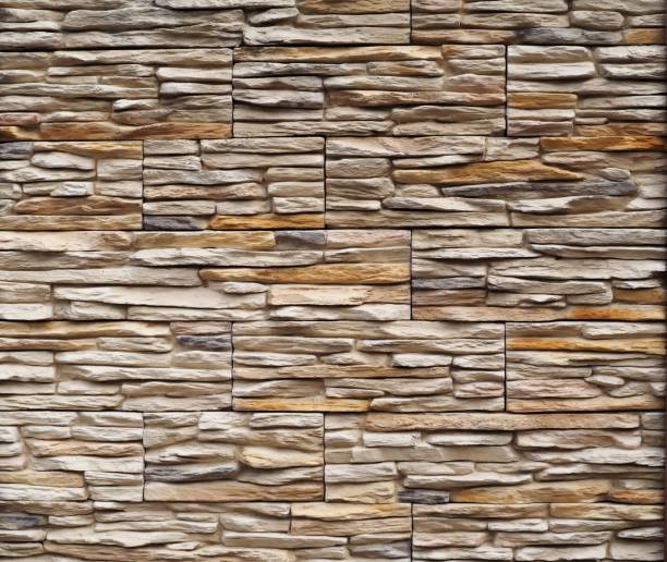 istock Background and texture. Modern wall made of natural broken stones with embossed structure 870844078
