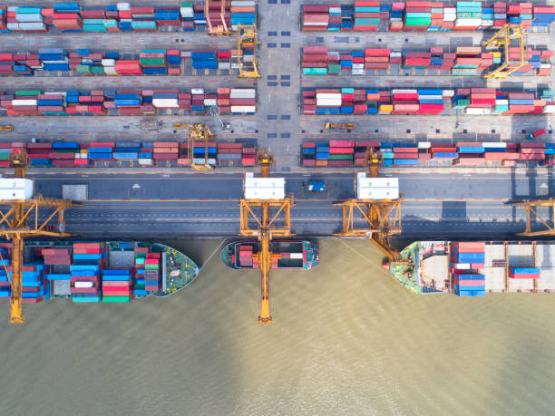 istock container,container ship in import export and business logistic,By crane,Trade Port , Shipping,cargo to harbor.Aerial view,Water transport,International,Shell Marine,transportation,logistic,trade,port 870844082