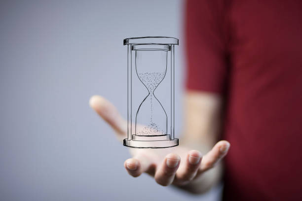 istock businessman holding sandglass in hand 870847072