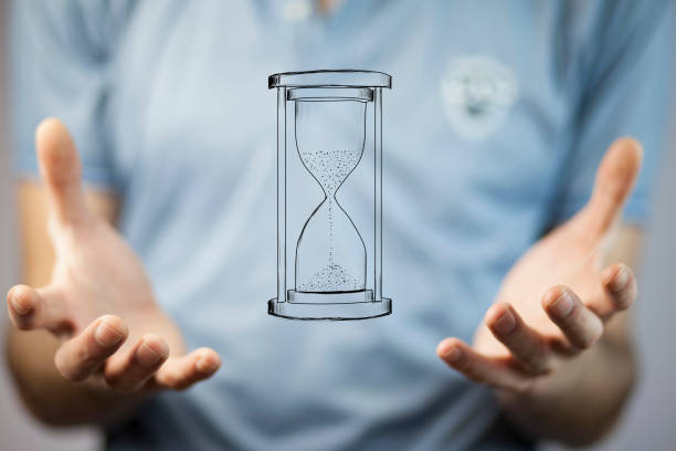 istock businessman holding sandglass in hand 870847080
