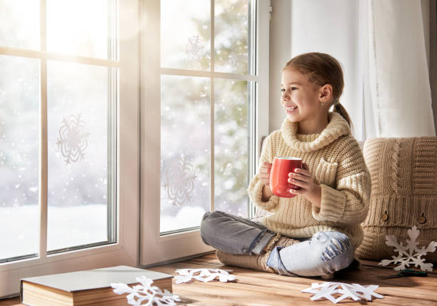 istock Child makes paper snowflakes 870857948