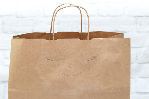 istock Paper shopping bag with smile drawn. Shopping 870860340