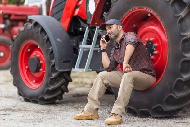 istock Doing business on the farm farmer and tractor 870861636