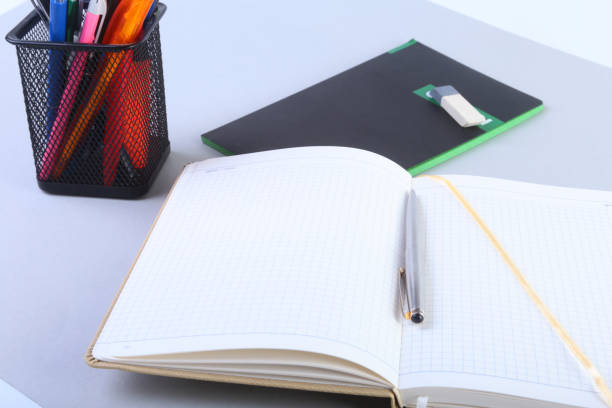 istock Colorful notebooks and office supplies on white table. 870868000