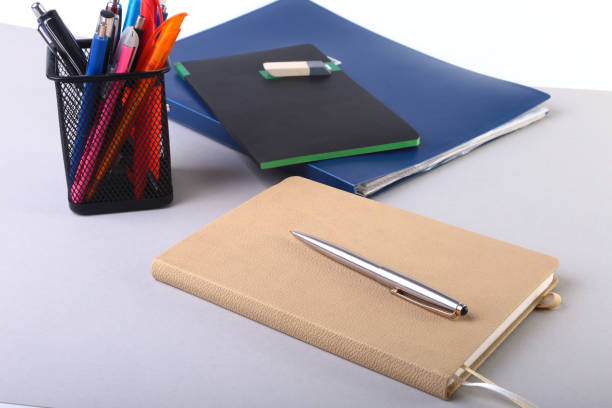istock Colorful notebooks and office supplies on white table. 870868046