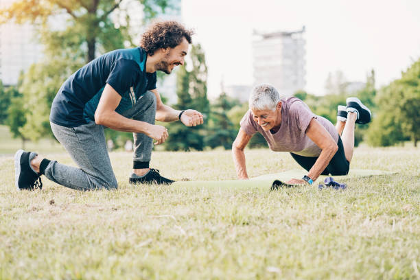 istock Senior woman making push-ups in the park 870870412