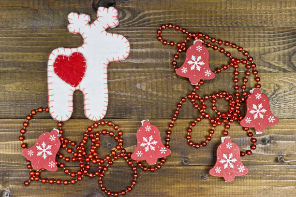 istock White deer of felt on wooden texture. 870874166