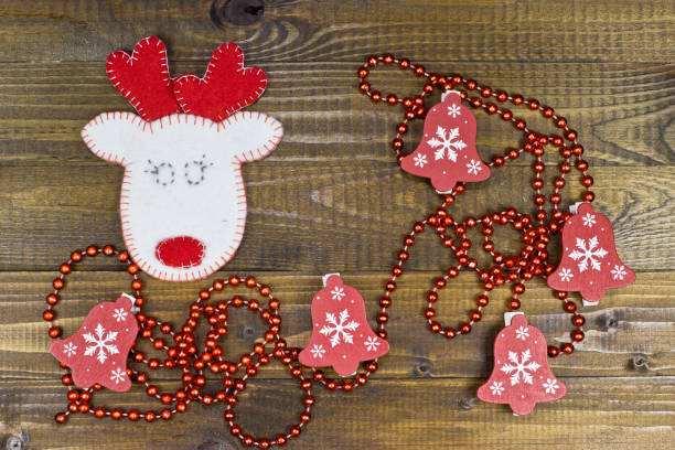 istock White deer of felt on wooden texture. 870874170