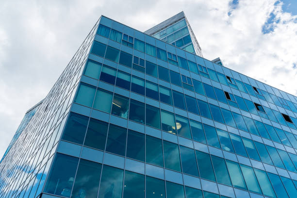 istock Glass office building on sky background 870878624