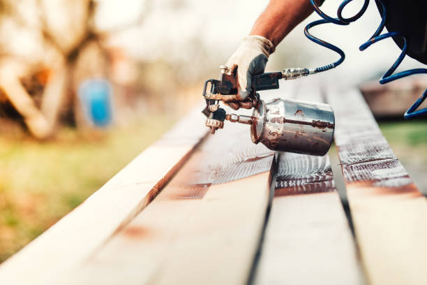 istock close-up of industrial worker using paint gun or spray gun for applying paint 870879130