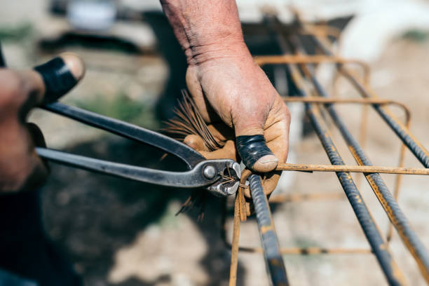 istock Armature bars in construction site, hands of builder, construction worker on site 870884240
