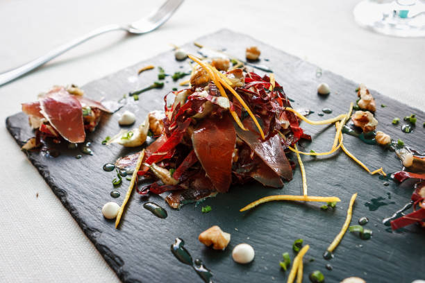istock Speck (smoked ham) appetizer in Cortina D'Ampezzo, Dolomites, Italy. 870894364