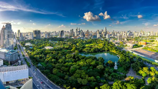 Sunset scence of Bangkok skyline Panorama ,Aerial view of Bangkok modern office buildings and condominium in Bangkok city downtown with sunset sky and clouds at Bangkok , Thailand. Lumpini park