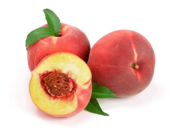 istock Peaches and half with green leaf isolated on white background 870895234