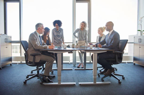 istock Diverse colleagues talking together in a boardroom in an office 870897786