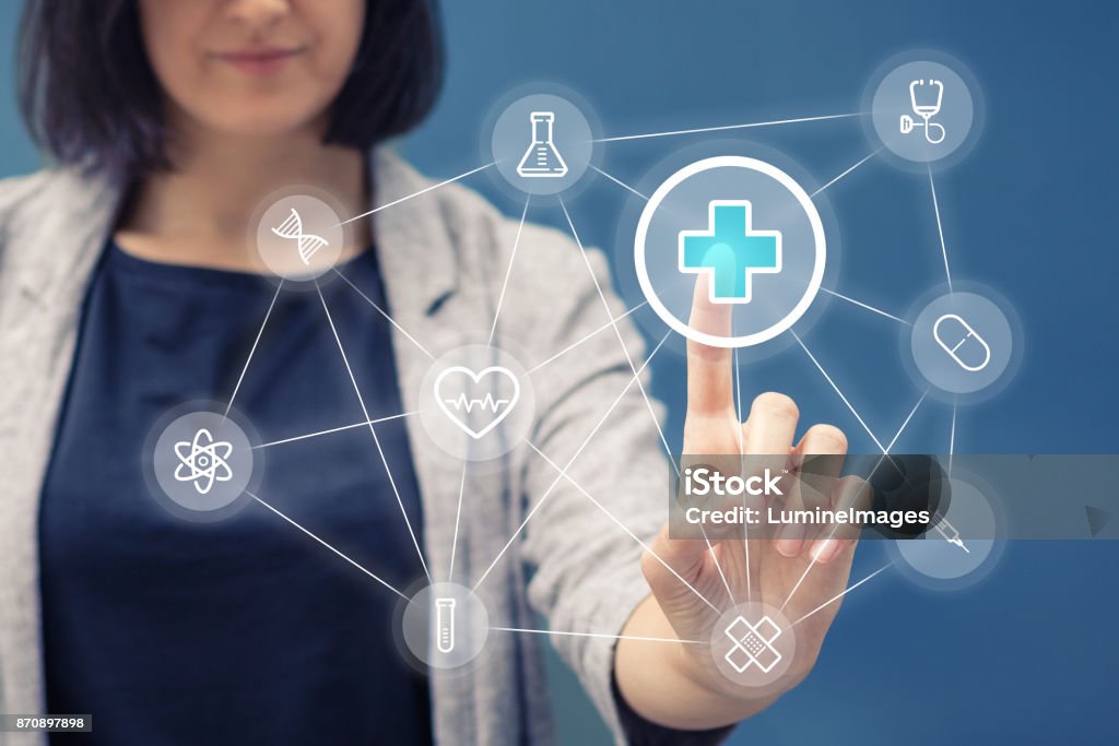 Healthcare application on touch screen. Woman pressing red cross sign on healthcare application on touch screen. Medicine and healthcare concept. Healthcare And Medicine Stock Photo