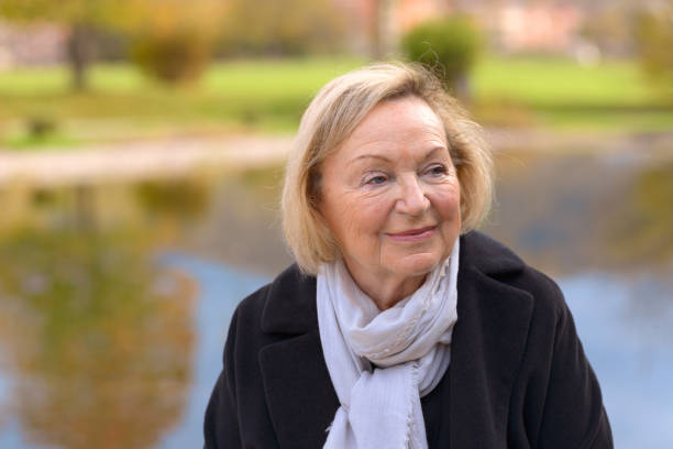 istock Elderly woman enjoying a fall day outdoors 870899400
