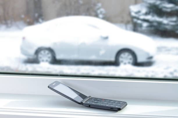 istock Old cell phone with car in snow 870906280
