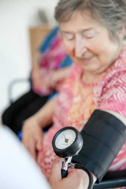 istock Senior Woman Blood Pressure Measuring 870909472