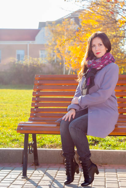 istock woman on a bench 870912240