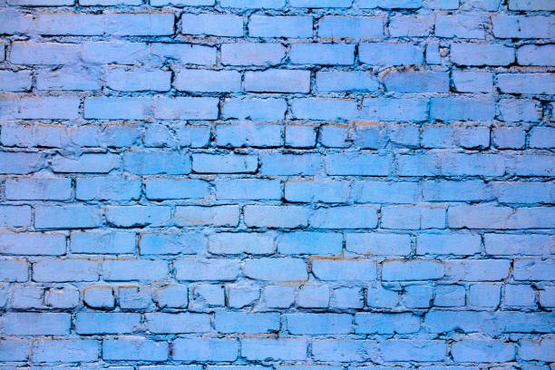 istock Brick wall. The brick wall painted in blue 870915834