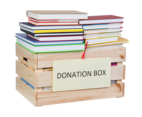 Donation box full of books isolated on white background