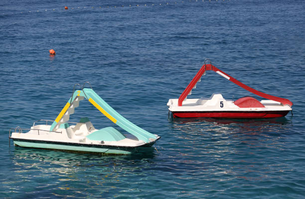 istock Two pedal boats float in sea 870934878