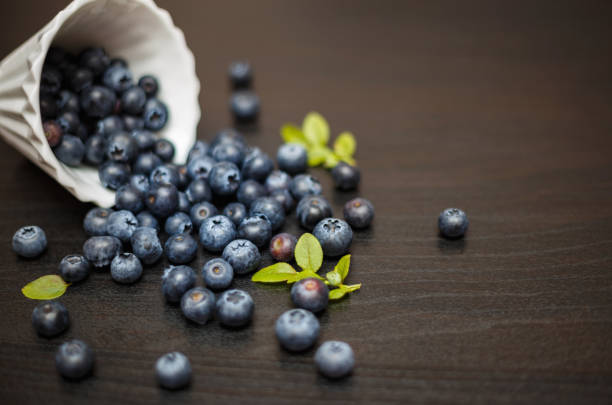 Fresh blueberries with leafs on dark background stock photo