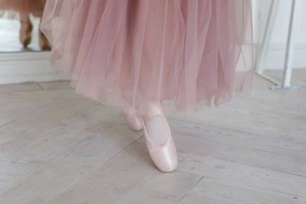 istock Ballerina puts pointe shoes 870947636