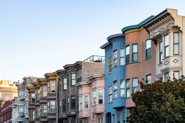Sunset light shines on a row of colorful buildings on Filbert Street in San Francisco, California stock photo