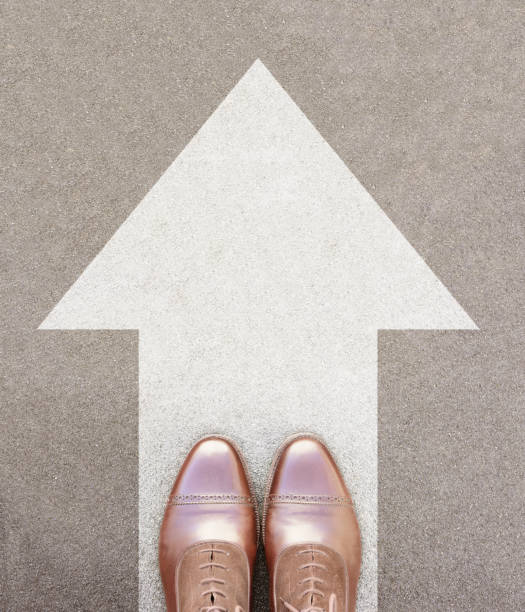 istock Just forward. Big arrow and perfect kept different business shoes. 870951150
